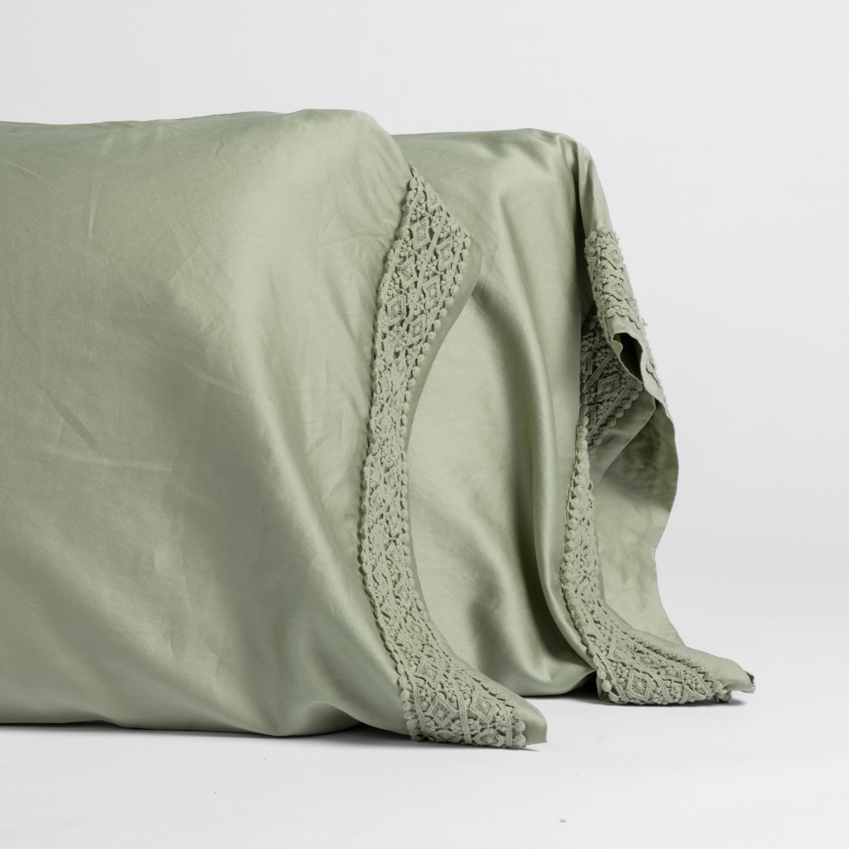 Bria Pillowcase (Single) | Desert Sage | matching pillowcases with lace in desert sage, a serenely elegant green, offering a hushed hue, shown against a plain background.