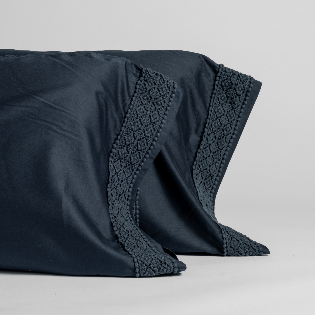 Bria Pillowcase (Single) | Slate | cotton sateen witth cotton lace trimmed pillowcase pair shown upright against a plain white background.