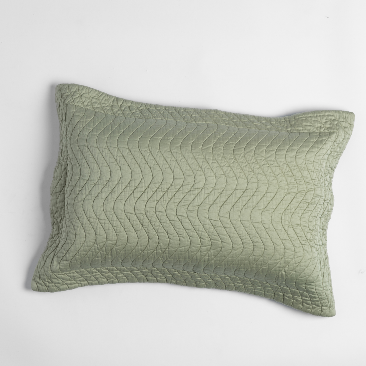 Cirillo Throw Pillow | Desert Sage | shot from overhead, a throw pillow in desert sage, a serenely elegant green, offering a hushed hue, shown against a plain background.