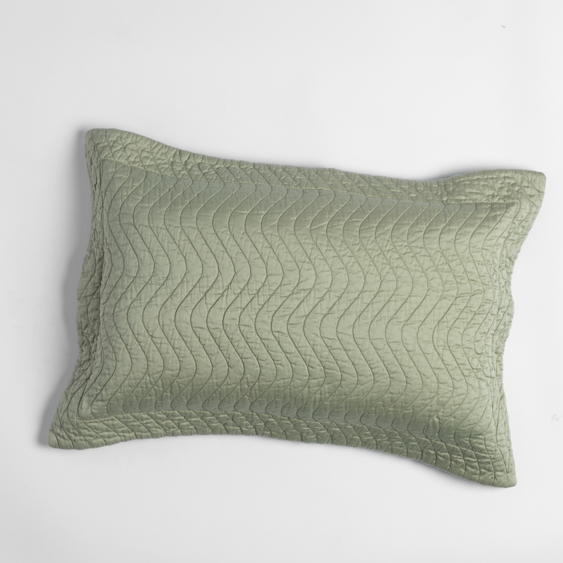 Cirillo Throw Pillow | Desert Sage | shot from overhead, a throw pillow in desert sage, a serenely elegant green, offering a hushed hue, shown against a plain background.
