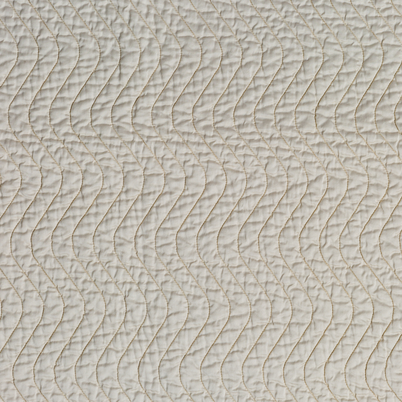 Cirillo Throw Pillow | Parchment | A close up of quilted cotton sateen fabric in parchment, a warm, antiqued cream.