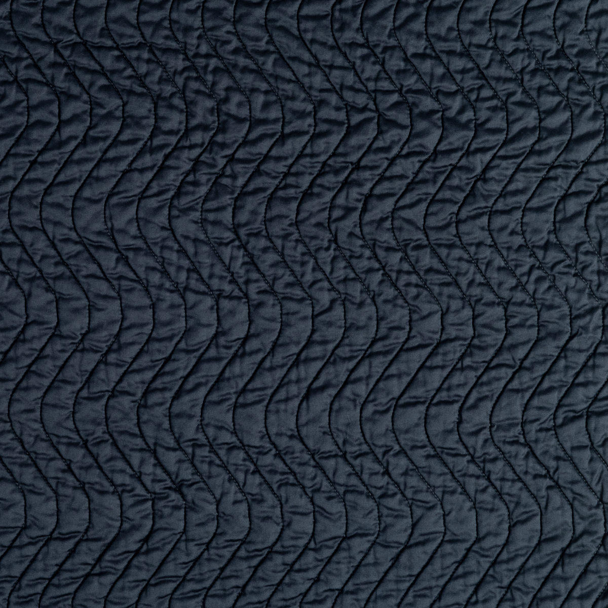 Cirillo Coverlet | Slate | a close-up of quilted cotton sateen fabric in slate, a polished dusky dark blue