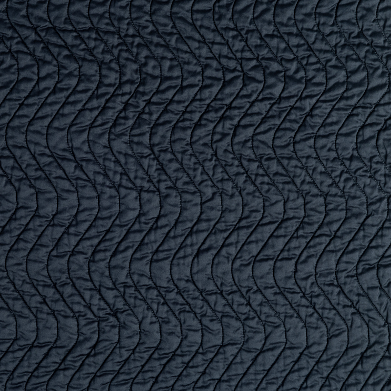 Cirillo Coverlet | Slate | a close-up of quilted cotton sateen fabric in slate, a polished dusky dark blue