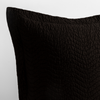 Cirillo Throw Pillow | Corvino | a close up of a pillow corner showing the flange framing quilted cotton sateen shot against a white background.