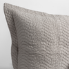 Cirillo Throw Pillow | Fog | a close up of a pillow corner showing the flange framing quilted cotton sateen shot against a white background.