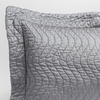 Cirillo Throw Pillow | Moonlight | a close up of a pillow corner showing the flange framing quilted cotton sateen shot against a white background.