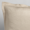 Cirillo Throw Pillow | Parchment | a close up of a pillow corner showing the flange framing quilted cotton sateen shot against a white background.