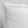 Cirillo Throw Pillow | White | a close up of a pillow corner showing the flange framing quilted cotton sateen shot against a white background.