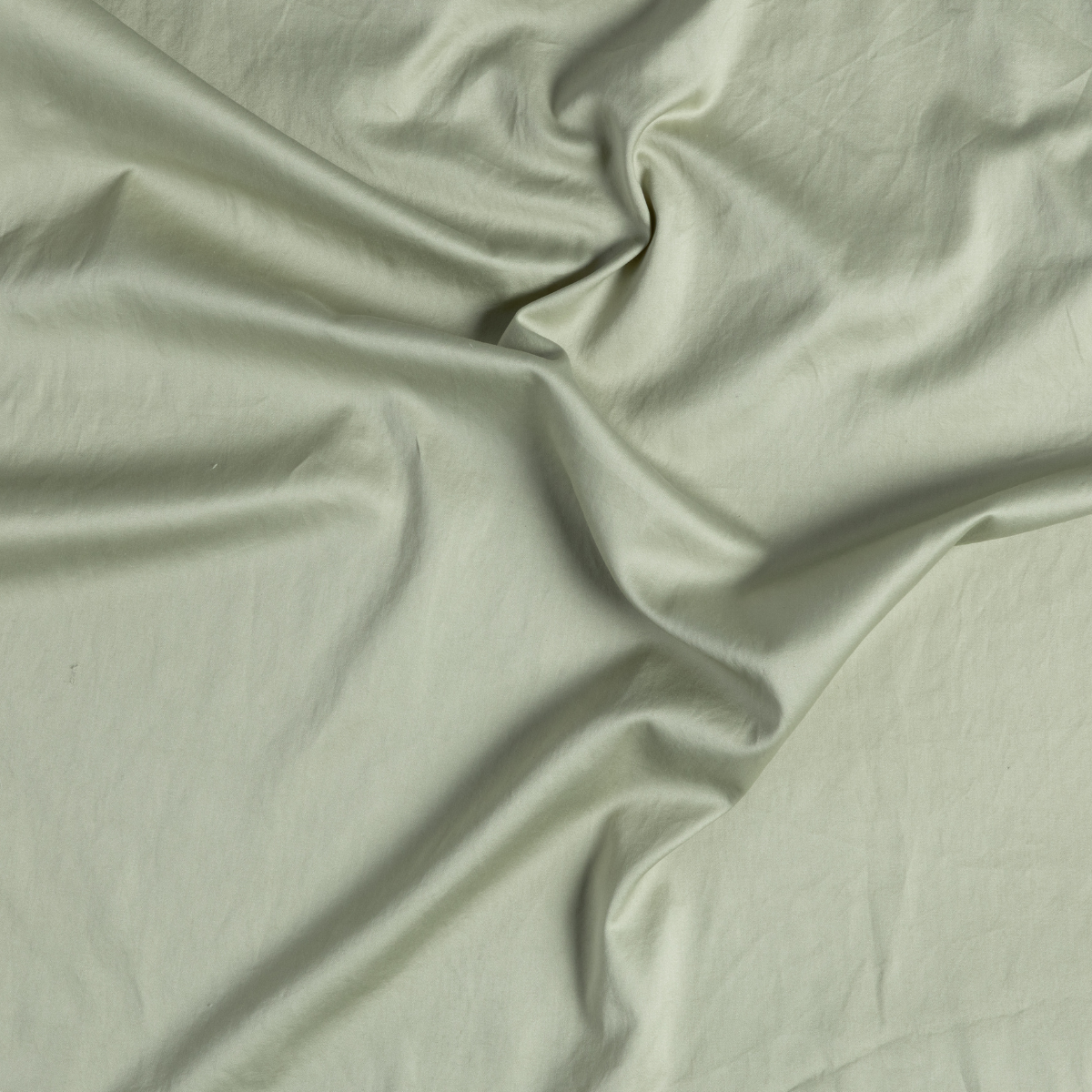 Bria Standard Pillowcase (Single) | Desert Sage | close-up of cotton sateen fabric gently rumpled in desert sage, a serenely elegant green, offering a hushed hue.