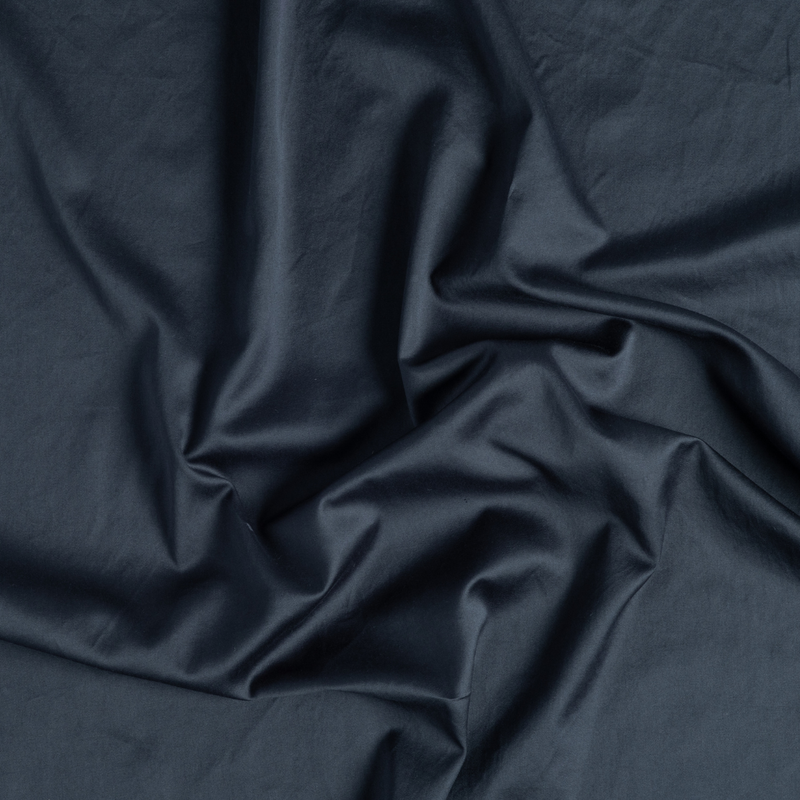 Bria Standard Pillowcase (Single) | Slate | a close-up of gently swirled cotton sateen fabric in slate, a polished dusky dark blue