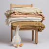Mirabella Baby Bundle - Holiday Release | stack of Mirabella Baby Blankets on a child-sized chair with a stuffed duck at the foot of one of the chair's legs - shot against a plain white background.