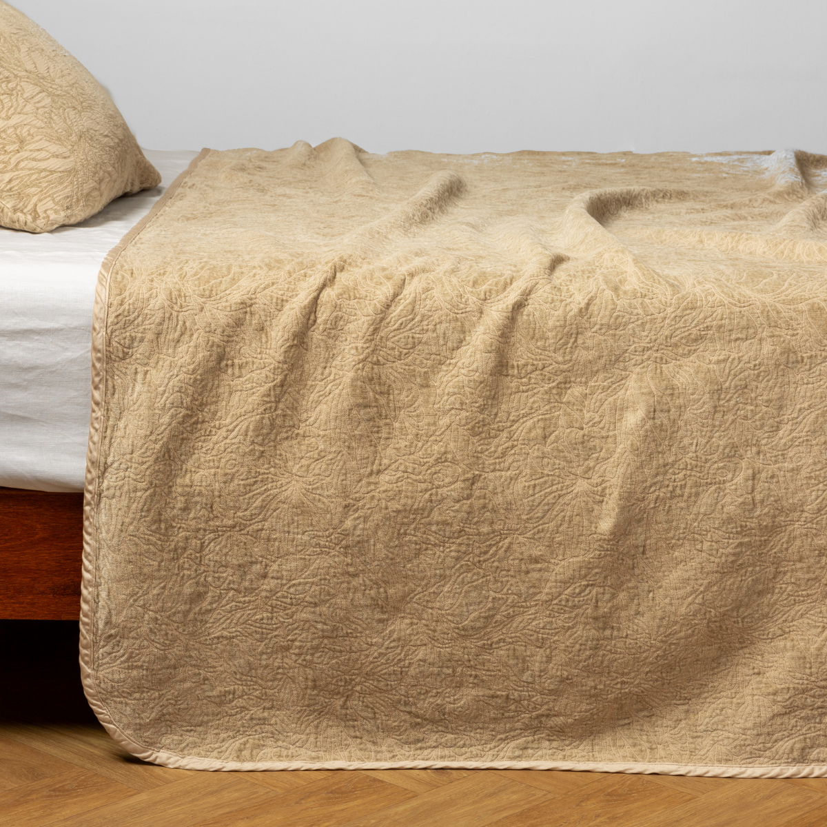 Georgia Bedspread | Honeycomb | side view of the chenille jacquard side of a bedspread with the cotton jacquard side showing on the matching sham — shown with a winter white fitted sheet.