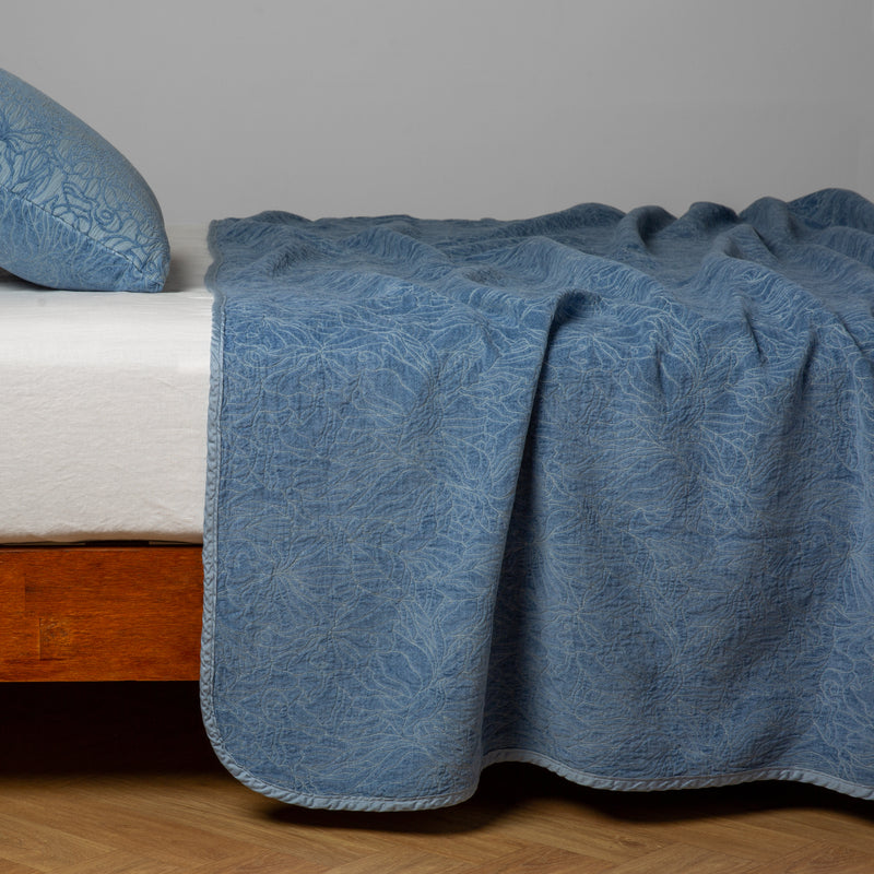 Georgia Bedspread | Tahoe Blue | side view of the chenille jacquard side of a bedspread with the cotton jacquard side showing on the matching sham — shown with a winter white fitted sheet.