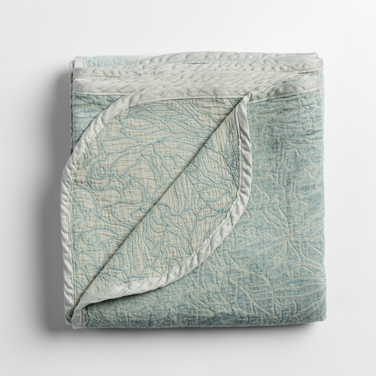 Georgia Blanket |  folded blanket with its cotton jacquard side visible on the corner foldback against the chenille jacquard side. 