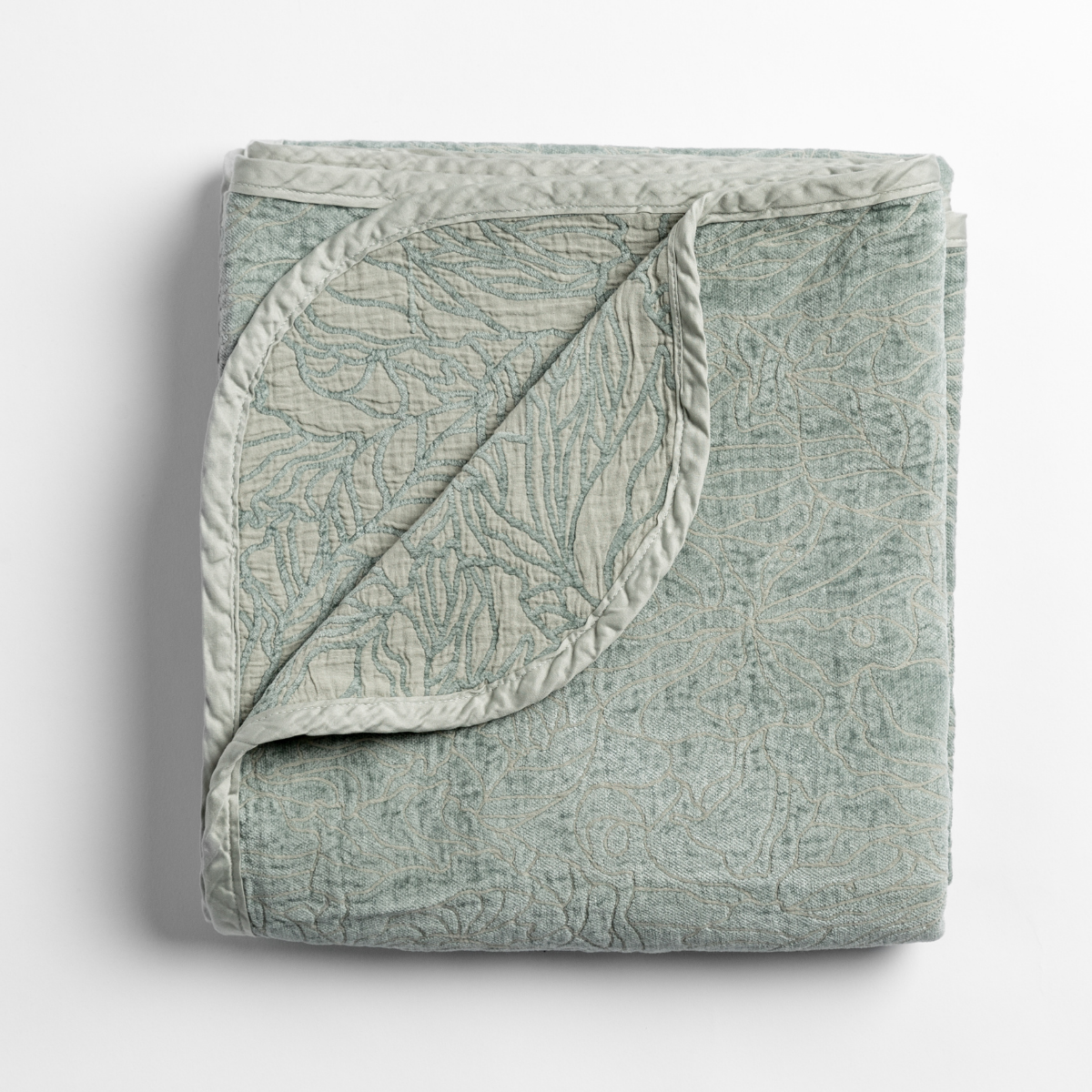 Georgia Blanket | Eucalyptus | folded blanket with its cotton jacquard side visible on the corner foldback against the chenille jacquard side.