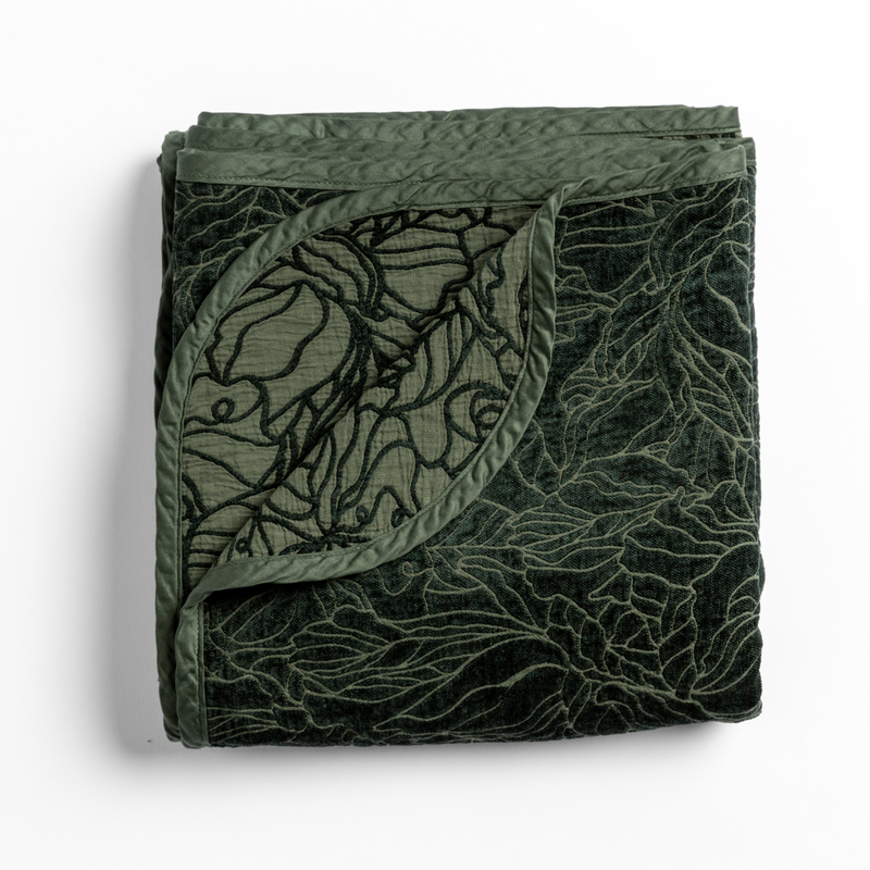 Georgia Blanket | Juniper | folded blanket with its cotton jacquard side visible on the corner foldback against the chenille jacquard side.