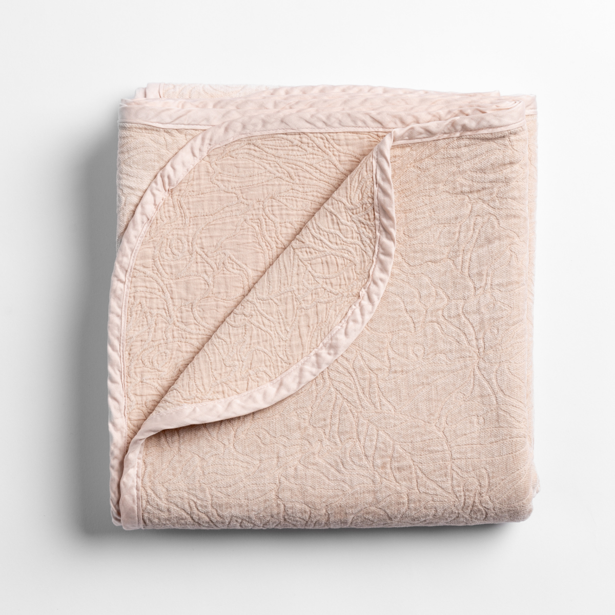 Georgia Blanket | Pearl | folded blanket with its cotton jacquard side visible on the corner foldback against the chenille jacquard side.