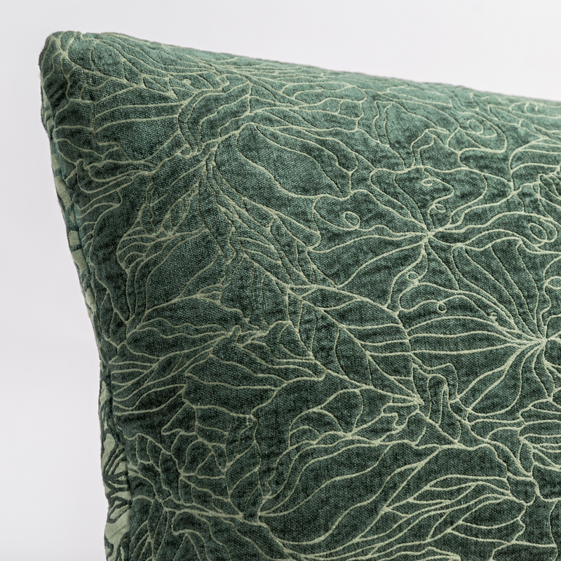 Georgia Throw Pillow | Juniper | close up of the chenille jacquard corner of a pillow cushion with a single-line floral pattern.