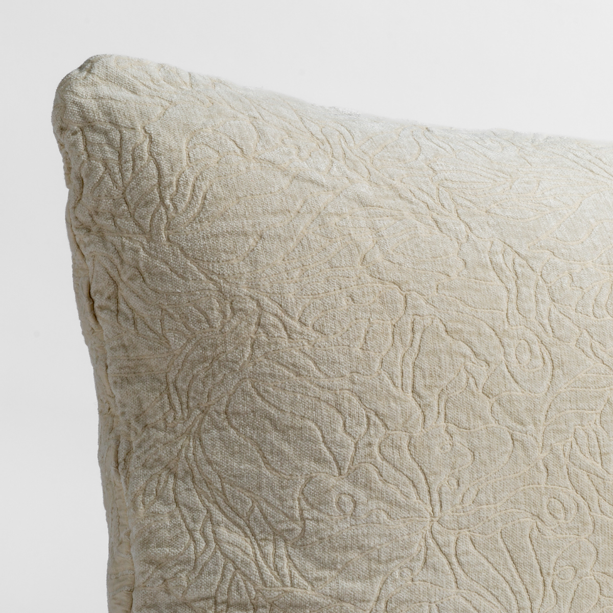 Georgia Throw Pillow | Parchment | close up of the chenille jacquard corner of a pillow cushion with a single-line floral pattern.
