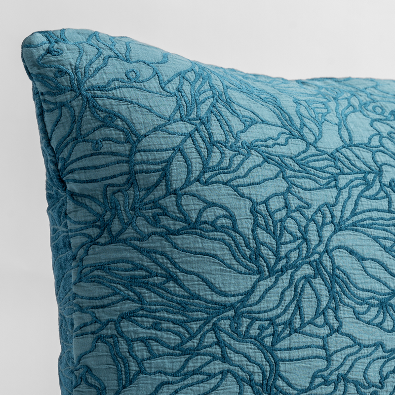 Georgia Throw Pillow | Cenote | close up of the cotton jacquard corner of a pillow cushion with a single-line floral pattern.