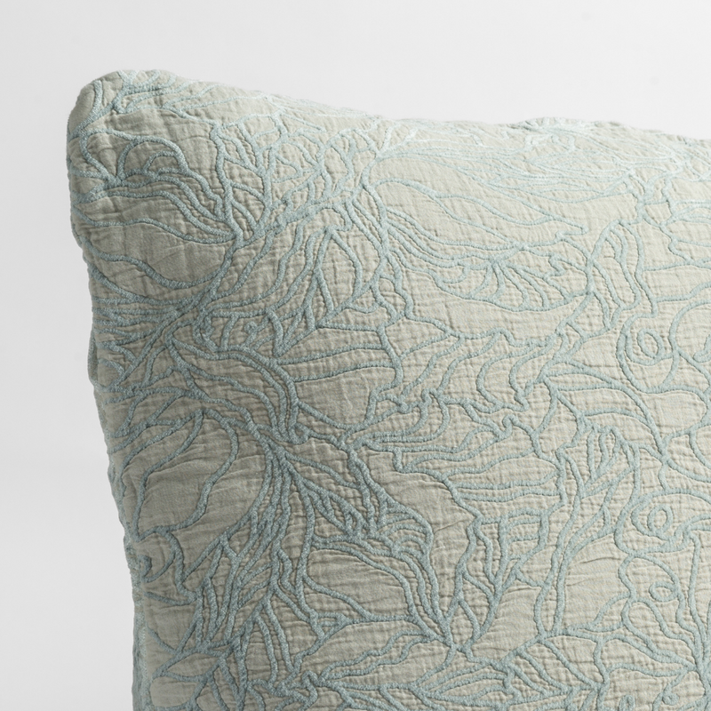 Georgia Throw Pillow | Cloud | close up of the cotton jacquard corner of a pillow cushion with a single-line floral pattern.