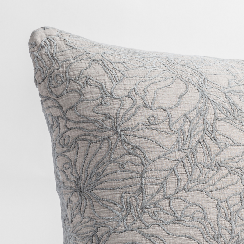 Georgia Throw Pillow | Fog | close up of the cotton jacquard corner of a pillow cushion with a single-line floral pattern.
