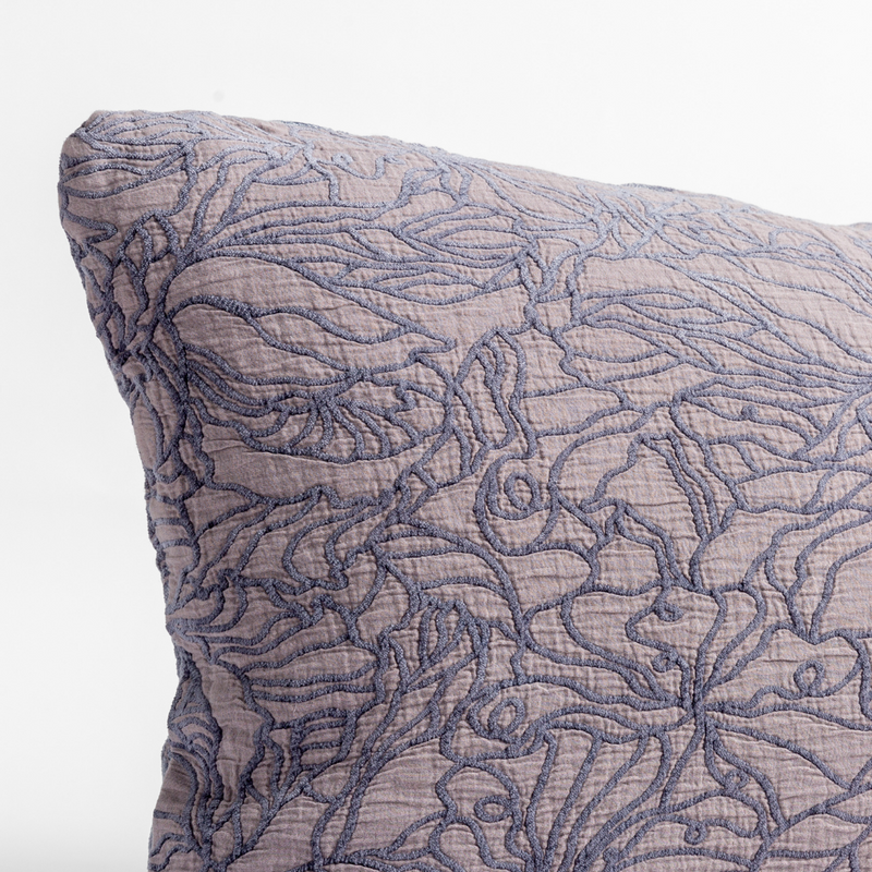 Georgia Throw Pillow | French Lavender | close up of the cotton jacquard corner of a pillow cushion with a single-line floral pattern.