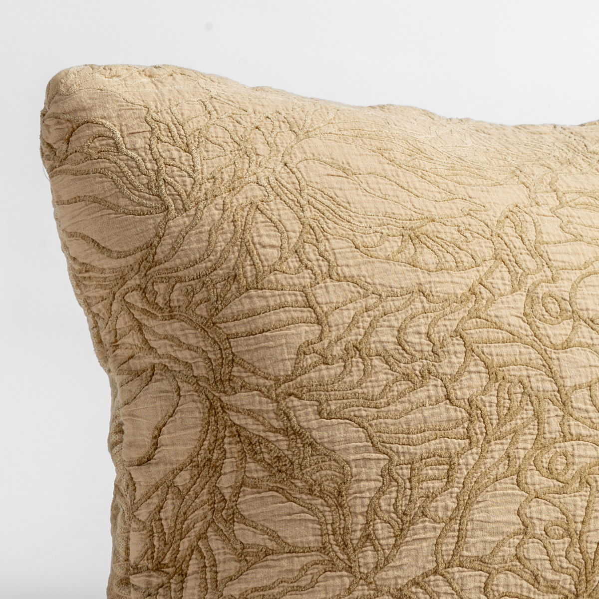 Georgia Throw Pillow | Honeycomb | close up of the cotton jacquard corner of a pillow cushion with a single-line floral pattern.