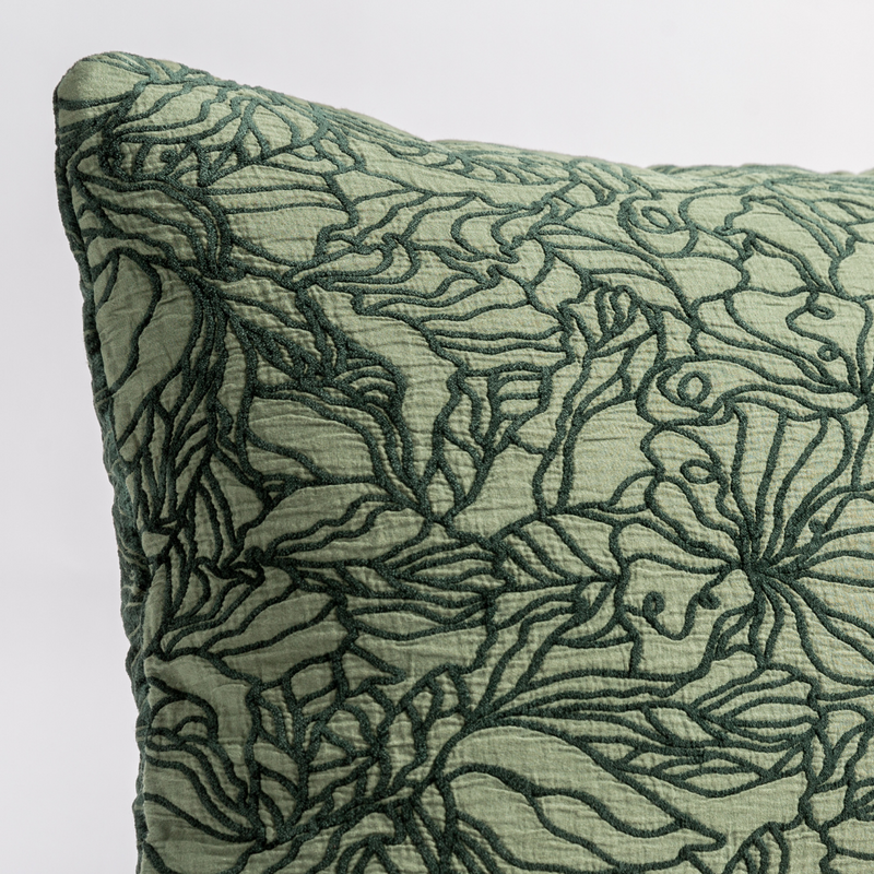 Georgia Throw Pillow | Juniper | close up of the cotton jacquard corner of a pillow cushion with a single-line floral pattern.