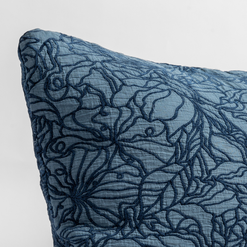 Georgia Throw Pillow | Midnight | close up of the cotton jacquard corner of a pillow cushion with a single-line floral pattern.