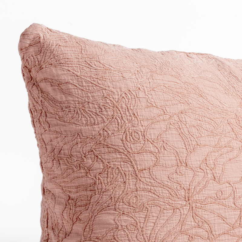 Georgia Throw Pillow | Rouge | close up of the cotton jacquard corner of a pillow cushion with a single-line floral pattern.