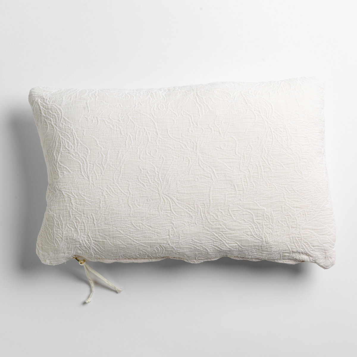 Georgia Throw Pillow | Winter White | cotton jacquard side of a rectangle throw pillow shown from overhead against a white background.