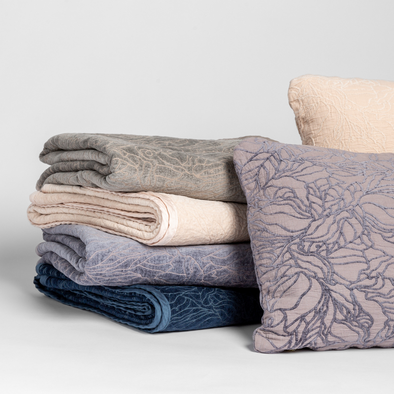 Georgia Blanket | a cluster of georgia throw blankets and pillows in multiple colors show off the pattern in both chenille and cotton jacquards. 