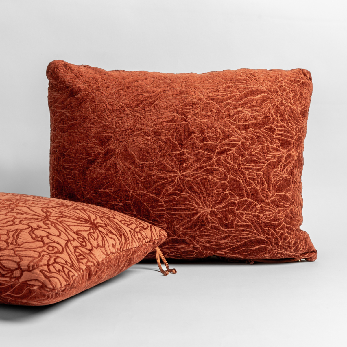 Autumn | A pair of Georgia Shams with the chenille jacquard sides shown in Autumn, a rich terracotta tone, shown against a white background.