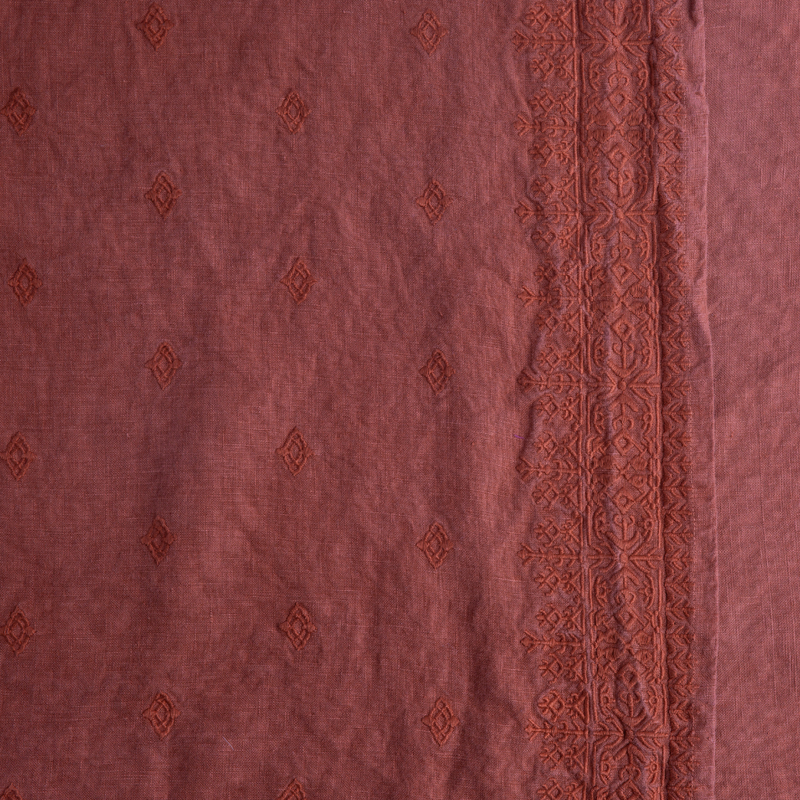 Ines Throw Pillow | Autumn | A close-up of Ines fabric in the colorway, Autumn, a rich terracotta tone.