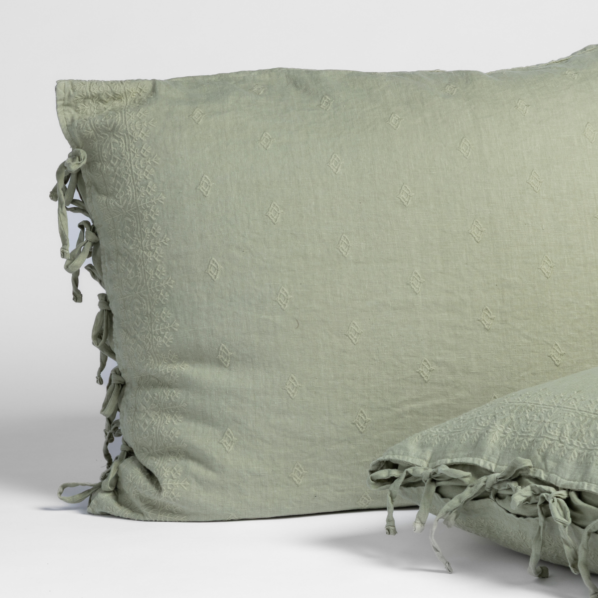 Ines Sham | Desert Sage | matching shams in desert sage, a serenely elegant green, offering a hushed hue, shown against a plain background.