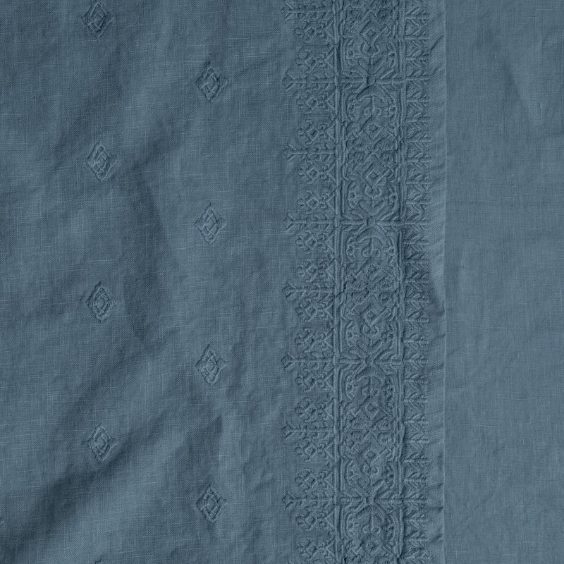 Ines Throw Pillow | Tahoe Blue | a close-up of the embroidery on midweight linen.