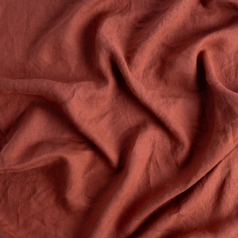 Linen Fitted Sheet | Autumn | A close-up of Linen fabric in the colorway, Autumn, a rich terracotta tone.