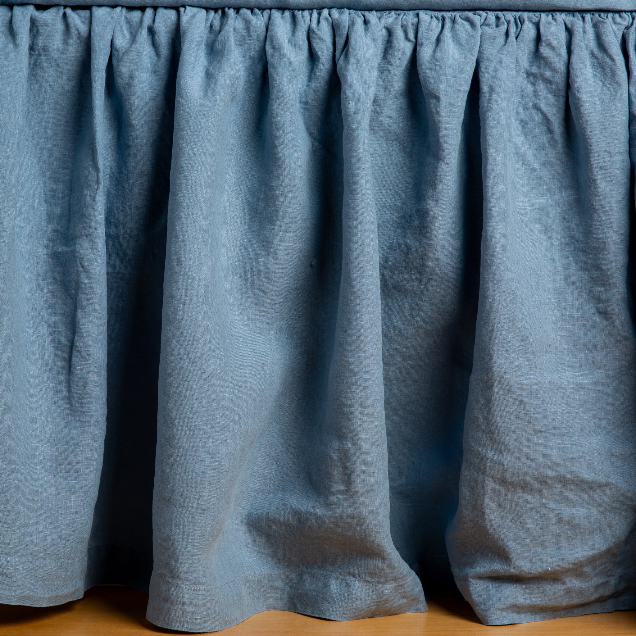 Linen Bed Skirt | Tahoe Blue | Close-up of bed skirt, featuring its softly gathered design.