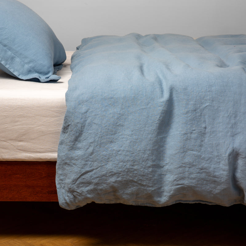 Linen Duvet Cover | Tahoe Blue | duvet cover over white linen sheeting - side view.