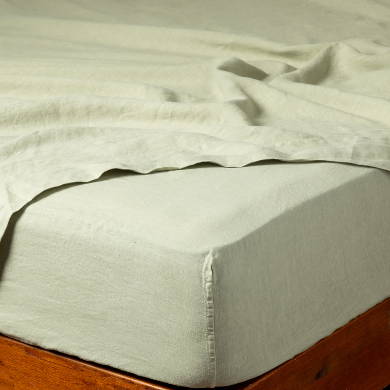Linen Twin Fitted Sheets | Desert Sage | a fitted sheet corner in desert sage, a serenely elegant green, offering a hushed hue, shown with a matching flat sheet.