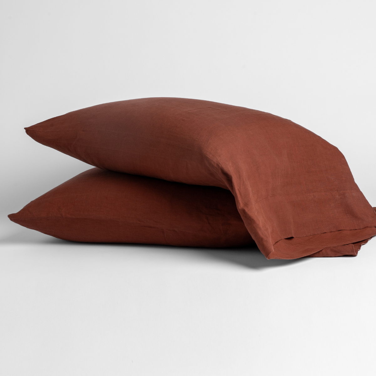 Linen Pillowcase (Single) | Autumn | A pair of Linen pillowcases in Autumn, a rich terracotta tone, shown against a white background.