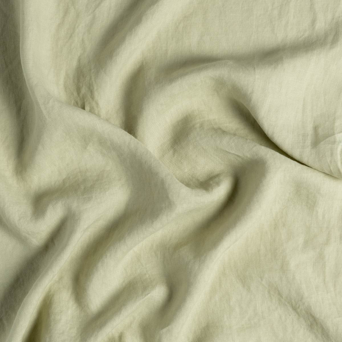 Linen Duvet Cover | Desert Sage | close-up of linen fabric gently rumpled in desert sage, a serenely elegant green, offering a hushed hue.