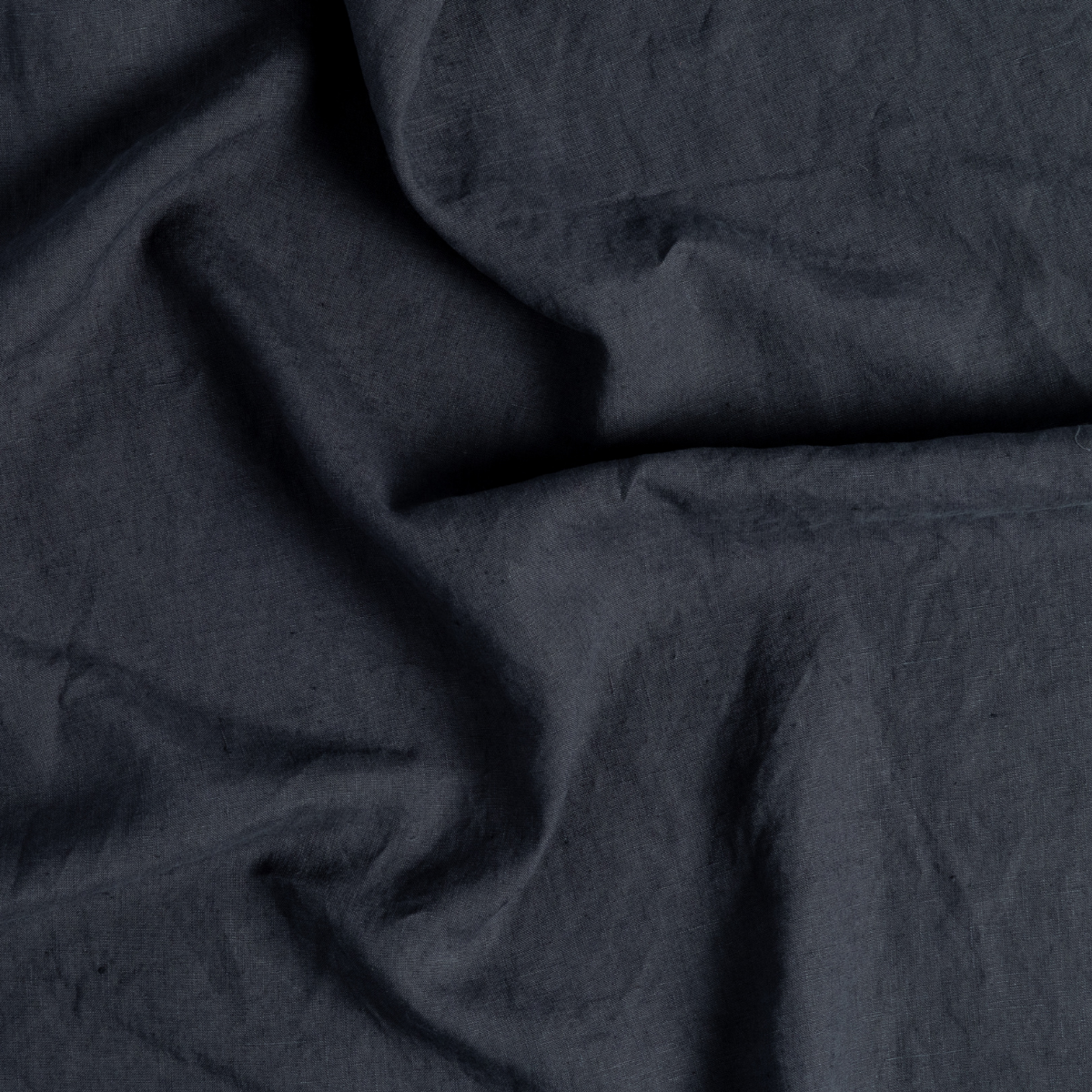 Linen Duvet Cover | Slate | a close-up of gently swirled signature linen fabric in slate, a polished dusky dark blue
