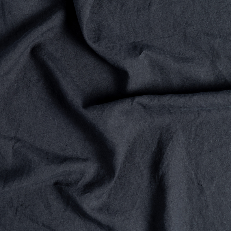 Linen Duvet Cover | Slate | a close-up of gently swirled signature linen fabric in slate, a polished dusky dark blue