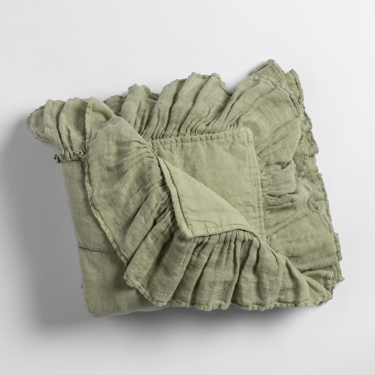 Linen Whisper Baby Blanket | Desert Sage | an overhead shot of a folded blanket in desert sage, a serenely elegant green, offering a hushed hue, shown against a plain background.