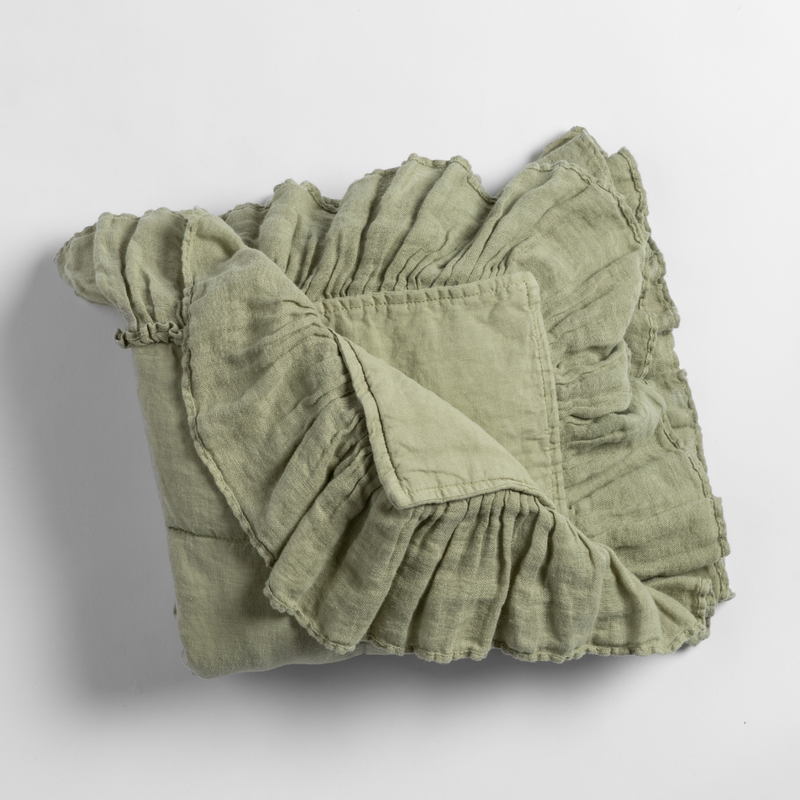 Linen Whisper Baby Blanket | Desert Sage | an overhead shot of a folded blanket in desert sage, a serenely elegant green, offering a hushed hue, shown against a plain background.