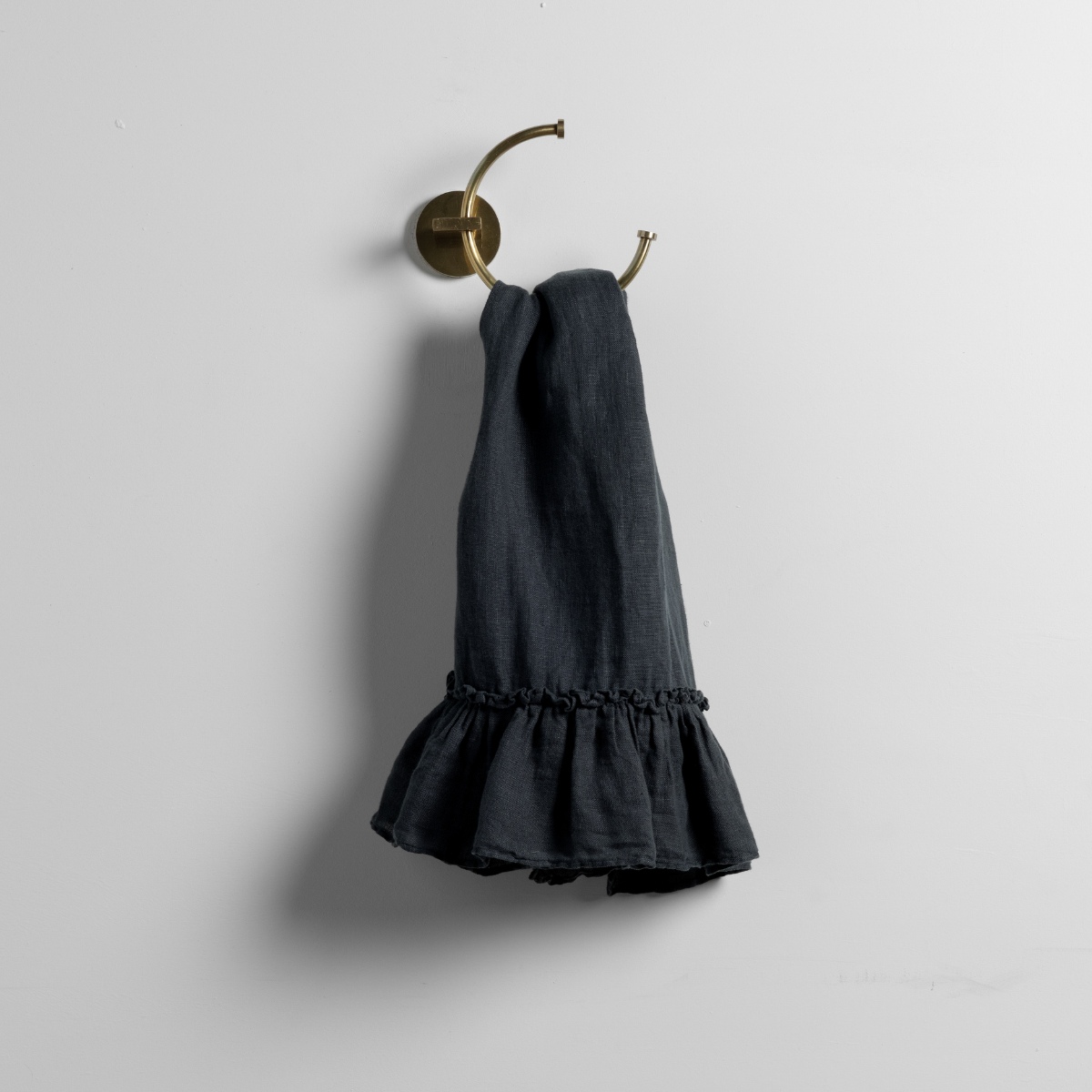 Linen Whisper Guest Towel | Slate | whisperweight linen guest towel on a decorative towel ring against a plain white background.