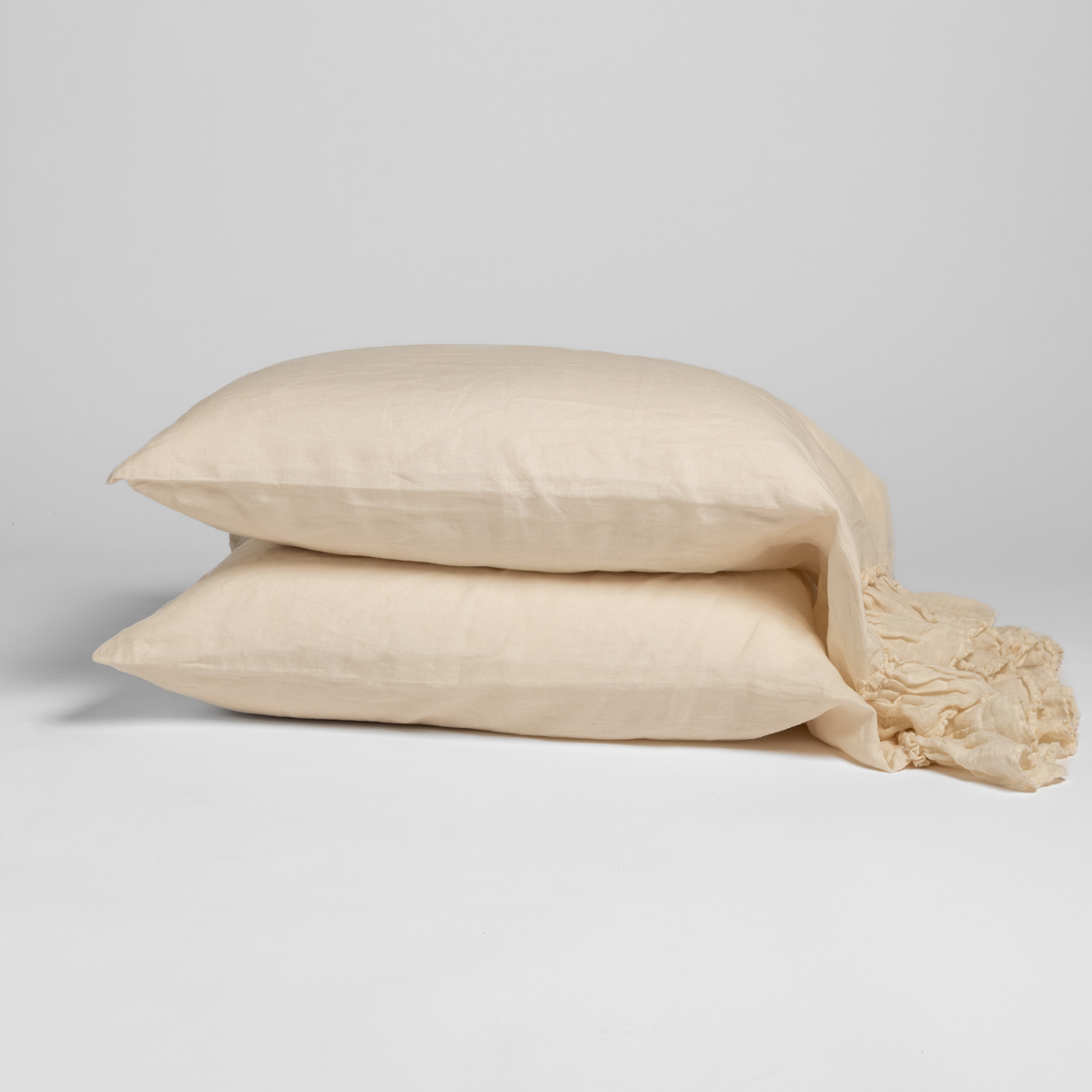 Linen Whisper Pillowcase (Single) | Natural | linen whisper trimmed pillowcase pair stacked against a plain background.