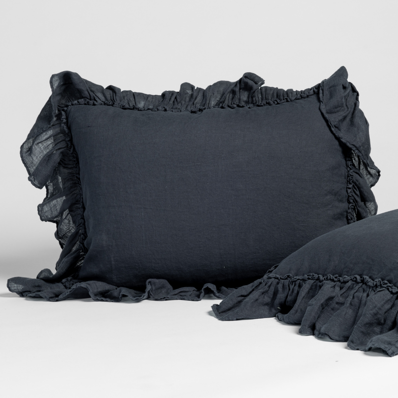Slate | matching pair of linen whisper shams in slate, a polished dusky dark blue, shown against a white background.
